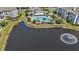 Aerial view of the lake and pool area with lounge chairs, shade umbrellas, and landscaping at 3741 Block House Way # 736, Myrtle Beach, SC 29577