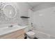Bathroom boasts a bathtub with shower, decorative mirror, and stylish shelving at 3741 Block House Way # 736, Myrtle Beach, SC 29577