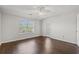 Bright bedroom features a ceiling fan, wood floors, a large window, and a door to the outside at 3741 Block House Way # 736, Myrtle Beach, SC 29577