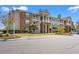 Attractive condo building featuring brick accents, balconies, and well-maintained landscaping at 3741 Block House Way # 736, Myrtle Beach, SC 29577