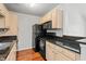 Efficient kitchen with light wood cabinets and black appliances at 3741 Block House Way # 736, Myrtle Beach, SC 29577
