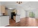 Open-concept room with hardwood floors next to the kitchen and balcony at 3741 Block House Way # 736, Myrtle Beach, SC 29577