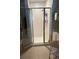 Bright bathroom featuring a glass-enclosed shower with tile surround and neutral-colored tile flooring at 4396 Baldwin Ave. # C-24, Little River, SC 29566