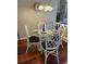 Cozy dining area with glass table and white woven chairs at 4396 Baldwin Ave. # C-24, Little River, SC 29566