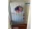 Charming gray front door adorned with patriotic wreath at 4396 Baldwin Ave. # C-24, Little River, SC 29566