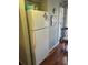 Spacious kitchen with full-size refrigerator and wooden flooring at 4396 Baldwin Ave. # C-24, Little River, SC 29566