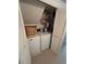Convenient laundry area with a stacked washer and dryer unit, and storage shelves at 4396 Baldwin Ave. # C-24, Little River, SC 29566