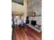 Open-concept living area with hardwood floors and a stone fireplace at 4396 Baldwin Ave. # C-24, Little River, SC 29566