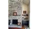Inviting living room features a stone fireplace and custom-built bar, perfect for entertaining guests at 4396 Baldwin Ave. # C-24, Little River, SC 29566