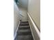 Carpeted staircase with white railings leading to the next level of the home at 4396 Baldwin Ave. # C-24, Little River, SC 29566