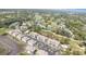 Aerial view of gray condos, golf course, and trees in a wooded area at 4409 Eastport Blvd. # E2, Little River, SC 29566