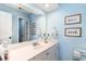 Bathroom featuring a white vanity, large mirror, and blue painted walls at 4409 Eastport Blvd. # E2, Little River, SC 29566