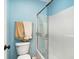 Bathroom with a toilet, towel rack, and glass shower doors at 4409 Eastport Blvd. # E2, Little River, SC 29566