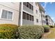 Exterior view of condos with enclosed porches and well-maintained landscaping at 4409 Eastport Blvd. # E2, Little River, SC 29566