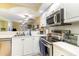 Updated kitchen featuring stainless steel appliances, white cabinetry, and modern countertops at 4409 Eastport Blvd. # E2, Little River, SC 29566