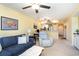 Open concept living room with comfortable seating, carpet floors, and a view into the kitchen at 4409 Eastport Blvd. # E2, Little River, SC 29566