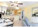 Open-concept living area with bar seating connecting to the kitchen in this bright condo at 4409 Eastport Blvd. # E2, Little River, SC 29566