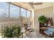 Inviting screened porch with cozy seating, plants, and a ceiling fan at 4409 Eastport Blvd. # E2, Little River, SC 29566