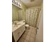 A cozy bathroom features a sink and cabinet, a toilet, and a bathtub with shower curtain at 4482 Little River Inn Ln. # 2004, Little River, SC 29566