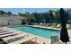 Community swimming pool surrounded by lounge chairs, ideal for relaxation and leisure at 4482 Little River Inn Ln. # 2004, Little River, SC 29566