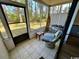 Enclosed sun room with an outdoor view, tile floors and a sitting area, providing a relaxing space at 4482 Little River Inn Ln. # 2004, Little River, SC 29566