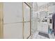 Cozy bathroom with a glass-enclosed shower, vanity, and classic floral wallpaper at 4679 Wild Iris Dr. # 103, Myrtle Beach, SC 29577