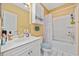 Bright bathroom featuring white cabinetry, a shower-tub combo, and neutral decor at 4679 Wild Iris Dr. # 103, Myrtle Beach, SC 29577
