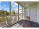 Relaxing screened-in patio with comfortable seating and views of the community gardens and the nearby building at 4679 Wild Iris Dr. # 103, Myrtle Beach, SC 29577