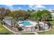 Inviting community pool area with ample seating, palm trees, and meticulous landscaping, ideal for leisure at 4679 Wild Iris Dr. # 103, Myrtle Beach, SC 29577