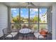 Relaxing screened porch with seating, offering serene views of the lush landscape at 4679 Wild Iris Dr. # 103, Myrtle Beach, SC 29577