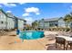 Sparkling community pool is surrounded by lounge chairs and well-maintained landscaping at 5905 South Kings Hwy. # 4202, Myrtle Beach, SC 29575