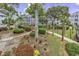 Lush courtyard featuring mature trees, trimmed hedges, and winding walkways amongst the buildings at 5905 South Kings Hwy. # 4202, Myrtle Beach, SC 29575