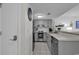 Cozy kitchen features stainless steel appliances, gray cabinets, tile backsplash, and a stylish eat-in counter at 5905 South Kings Hwy. # 4202, Myrtle Beach, SC 29575
