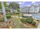 A landscaped pool area surrounded by well-maintained grounds and condominiums on a sunny day at 5905 South Kings Hwy. # 4202, Myrtle Beach, SC 29575