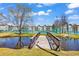 Scenic wooden bridge crosses to the community tennis courts with lush landscaping and blue skies at 5905 South Kings Hwy. # 4202, Myrtle Beach, SC 29575