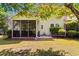 Home featuring a screened-in porch, a well-kept lawn, and lush landscaping at 6095 Catalina Dr. # 616, North Myrtle Beach, SC 29582