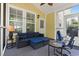 Comfortable screened porch with a cozy sofa, chair and tranquil outdoor views at 6095 Catalina Dr. # 616, North Myrtle Beach, SC 29582