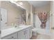 Well-lit bathroom featuring white vanity, framed mirror, and shower with bathtub at 621 Banks Dr. # 12-1, Myrtle Beach, SC 29588
