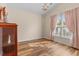 Bright bedroom with natural light, laminate floor, neutral paint, and pink window coverings at 621 Banks Dr. # 12-1, Myrtle Beach, SC 29588