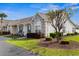Well-maintained single-story home with manicured landscaping, green grass, mature trees, and neutral colors at 621 Banks Dr. # 12-1, Myrtle Beach, SC 29588