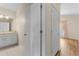 Hallway view of the full bathroom, closet, and bedroom with neutral paint and floors at 621 Banks Dr. # 12-1, Myrtle Beach, SC 29588