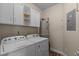 Laundry room featuring white washer and dryer with overhead cabinets and tile flooring at 621 Banks Dr. # 12-1, Myrtle Beach, SC 29588