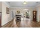 Living room with wood floors and a fireplace, leading into a sunroom at 621 Banks Dr. # 12-1, Myrtle Beach, SC 29588