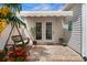 Paver patio features swing, colorful garden and French doors with awning at 621 Banks Dr. # 12-1, Myrtle Beach, SC 29588