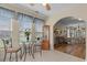 Sun room includes a ceiling fan, a glass table set, and tile flooring, creating a comfortable atmosphere at 621 Banks Dr. # 12-1, Myrtle Beach, SC 29588
