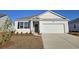 Charming single Gathering home with a two-car garage and manicured lawn at 705 Chazen Way, Longs, SC 29568