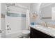 Cozy bathroom features a granite vanity, wood-look flooring, and a tub with tiled walls at 720 North Waccamaw Dr. # 312, Murrells Inlet, SC 29576