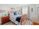Comfortable bedroom with a bed, floral bedding, wooden furniture, and soothing decor at 720 North Waccamaw Dr. # 312, Murrells Inlet, SC 29576