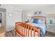 Bright bedroom with a queen bed, floral bedding, wood floors, and white walls at 720 North Waccamaw Dr. # 312, Murrells Inlet, SC 29576