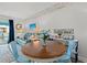 Cozy dining area with a round wooden table and blue chairs, creating a welcoming space at 720 North Waccamaw Dr. # 312, Murrells Inlet, SC 29576